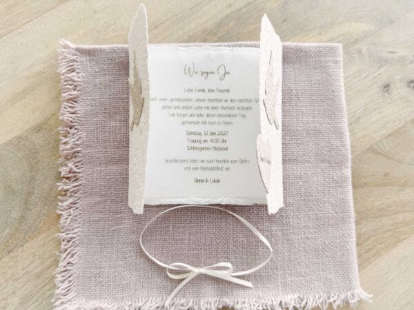 Hochzeitseinladung «Tauben» aus handgeschöpftem Papier im Gatefold Desing mit zwei beigen Tauben. Geöffnete Ansicht mit Blick auf das bedruckte Beispiel Innenblatt