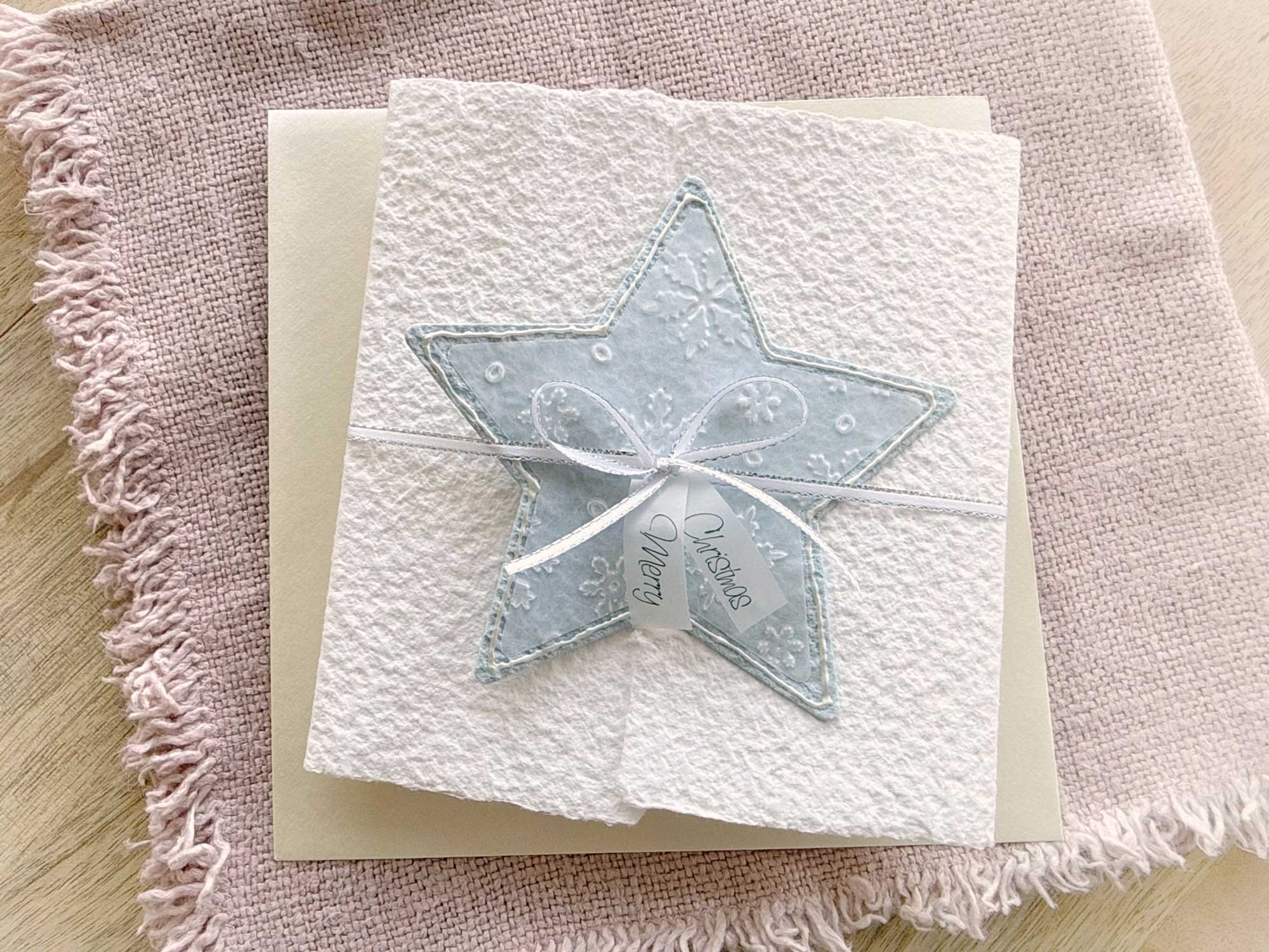 Handgeschöpfte Weihnachtskarte Stern in Hellblau mit Schneeflockenprägung